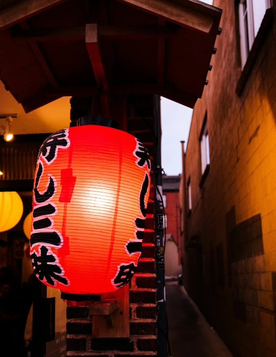 a large red lantern sitting next to a wall