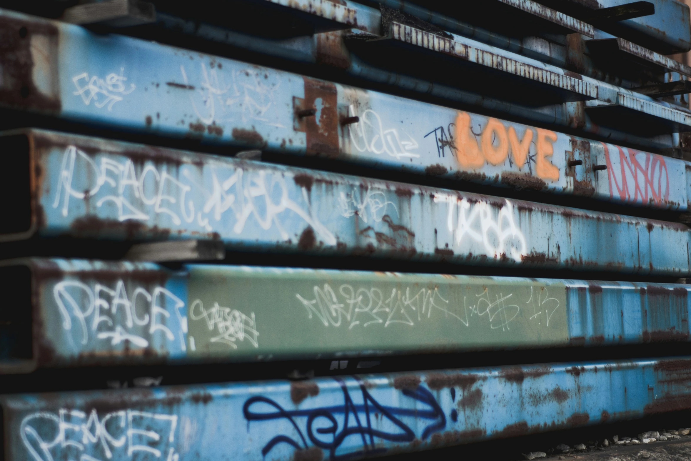 several large piles of metal are covered with graffiti