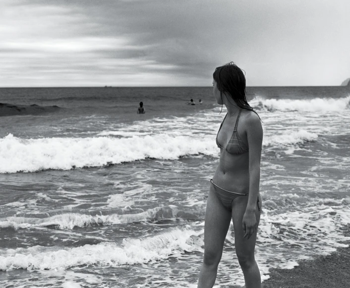 a woman in a bathing suit on a beach