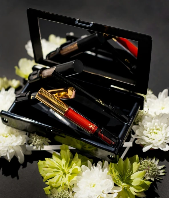 lipstick is displayed in an open case surrounded by flowers