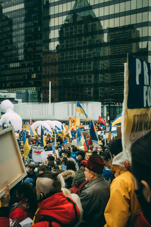 a crowd gathered outside a large building during a demonstration