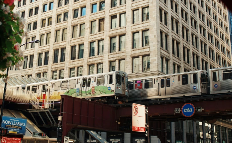 a very tall building with cars on a bridge