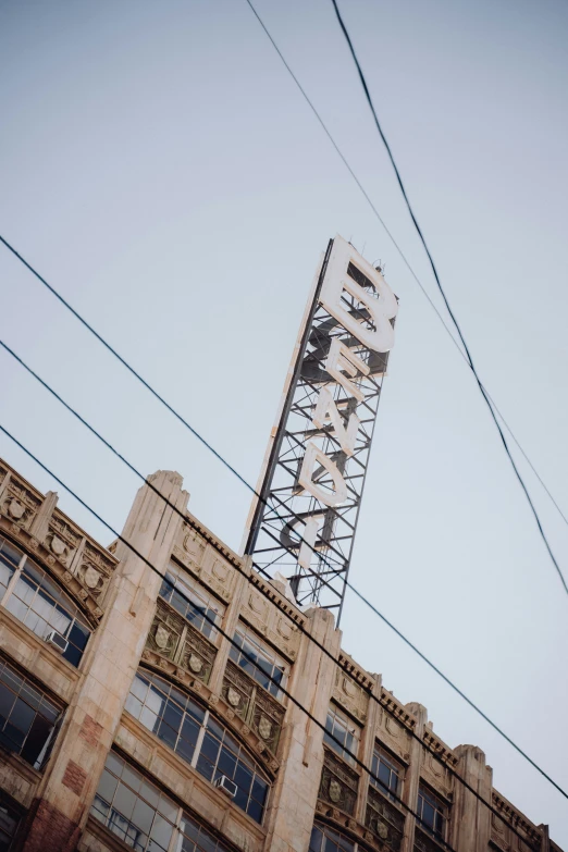 an abandoned building sitting in the middle of power lines