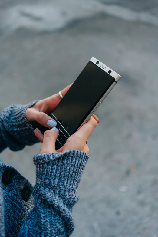 a woman is using her cell phone outside