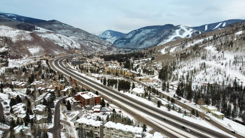 a town surrounded by mountains and snow covered ground