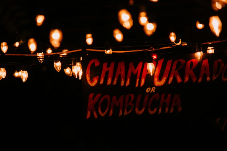 a sign that reads, restaurant kombucha on the light bulbs