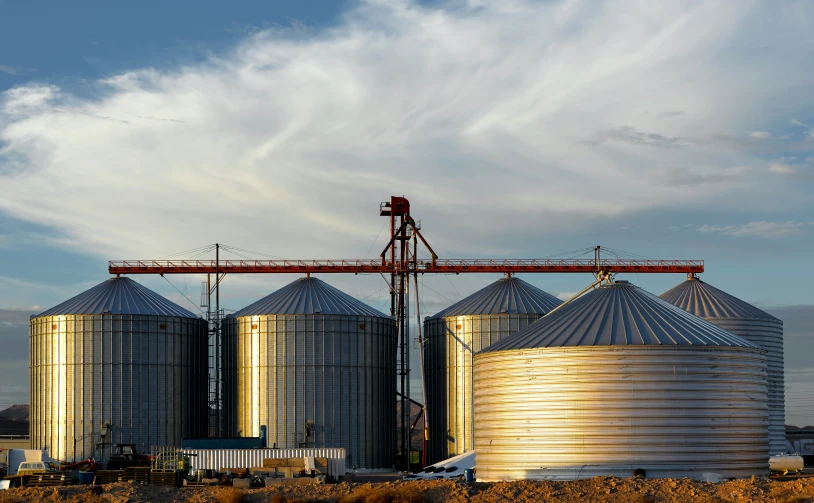 a couple of silos sitting near a farm