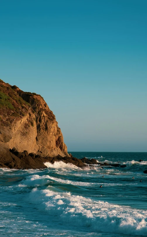 a beautiful landscape of waves on the rocks by the ocean