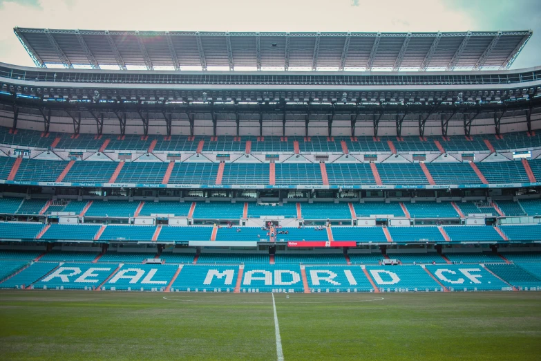 a stadium with a soccer field and some empty seats