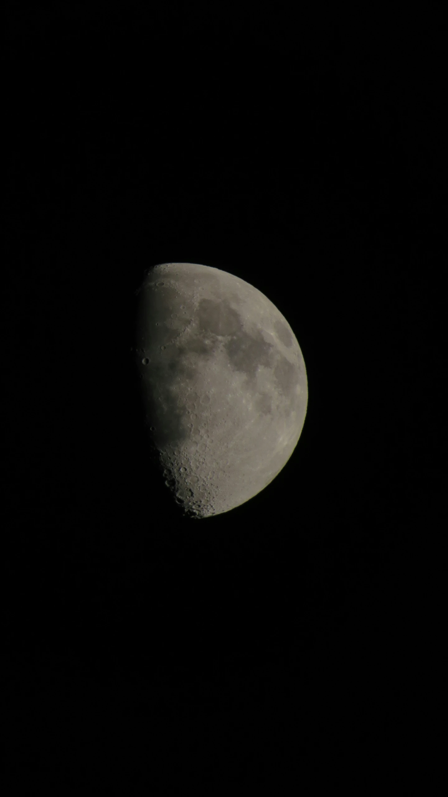 the moon in a black night sky with only one left side of the moon