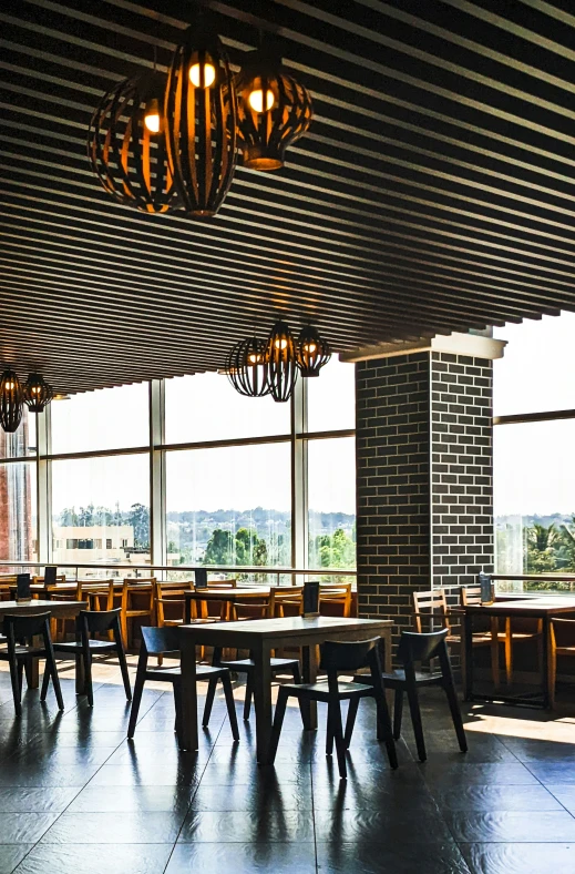 a restaurant has wood tables and chairs under the awnings