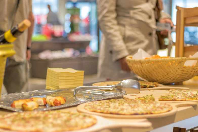 there are many different kinds of pizzas on the counter