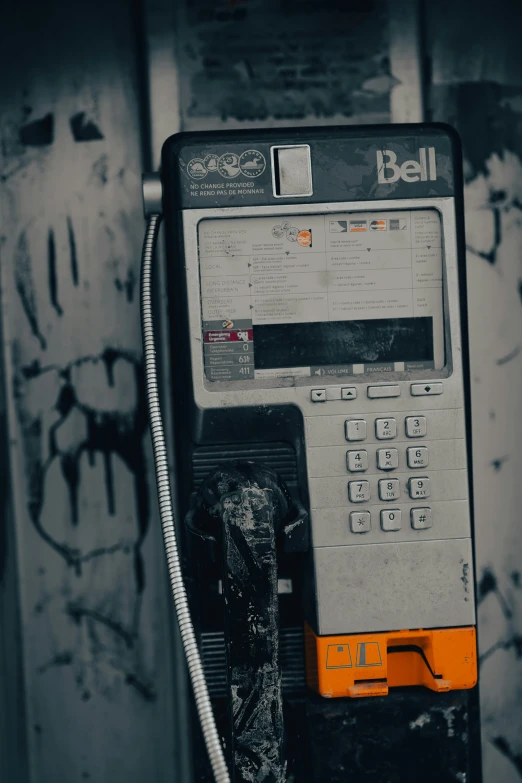 an old telephone is attached to a rusty wall