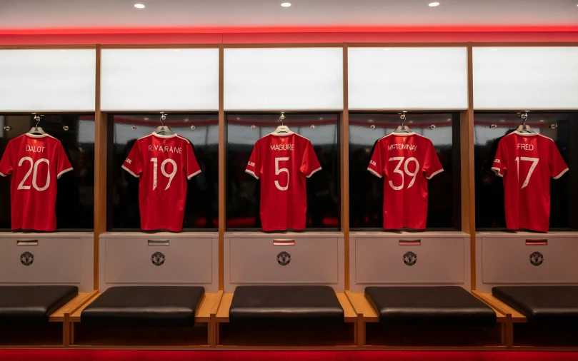 a locker with a number of red shirts on display