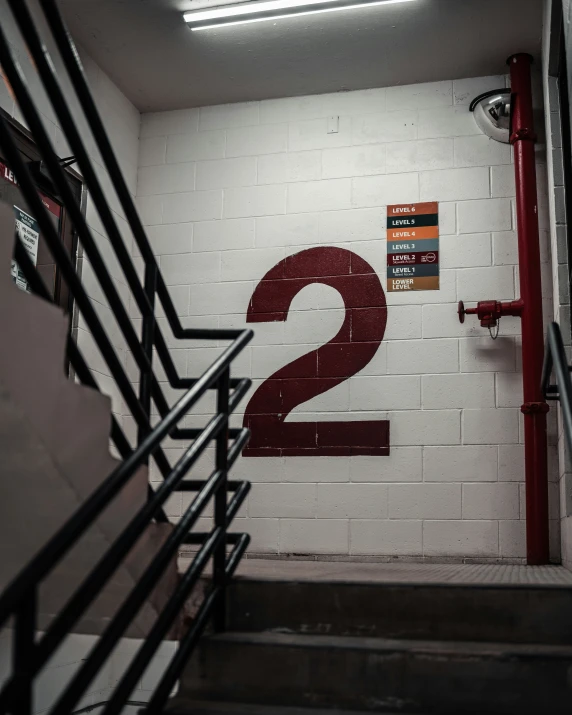 the number two is on the wall next to a stairwell