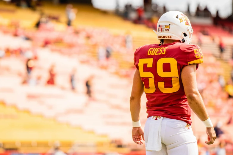 the man in the uniform of a football player with an empty field