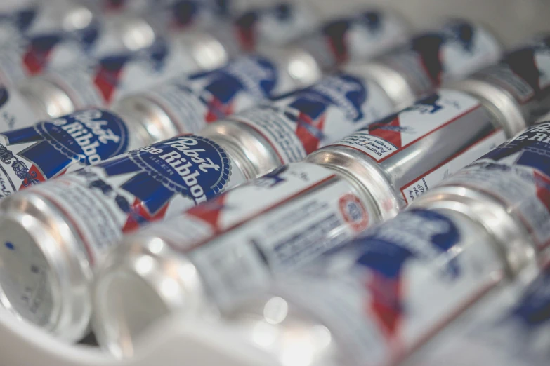 a group of canisters of drink are stacked up