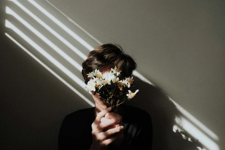 a person holding a bunch of white flowers