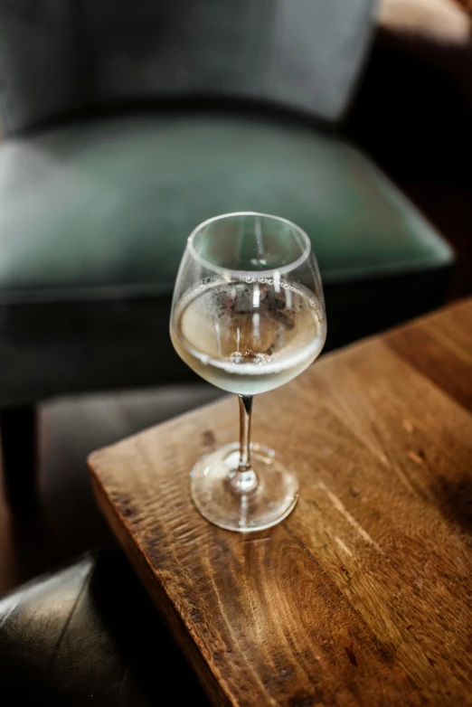 a glass sitting on top of a wooden table