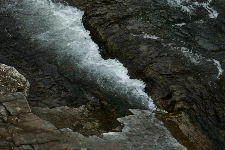 some water and a cliff side near one another