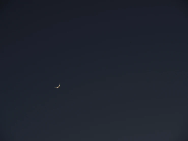 two moon in a dark sky with two stars