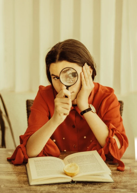 a person with glasses is looking at a book