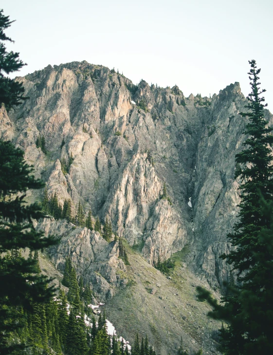 a scenic view of a mountain ridge from the valley below