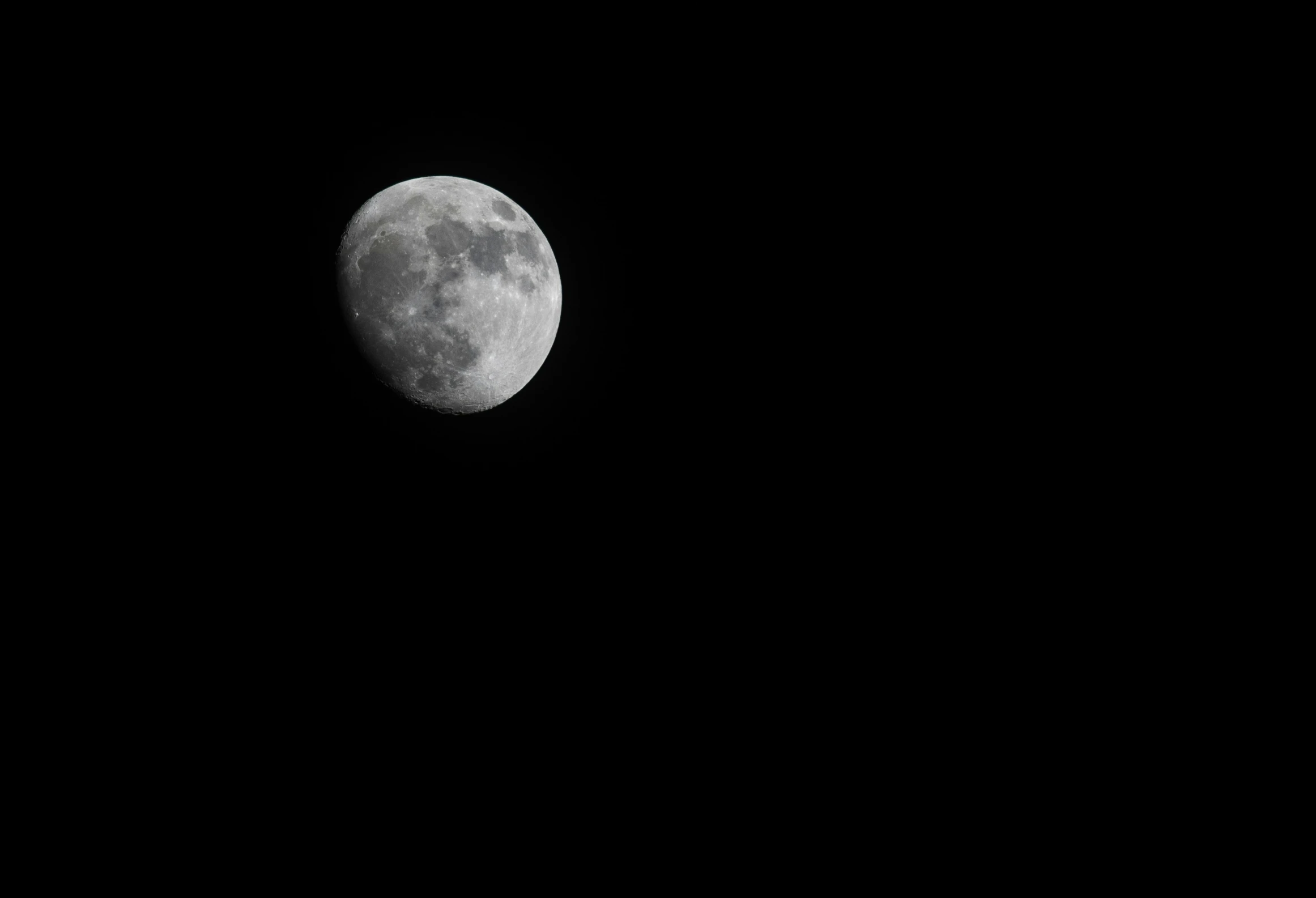 the moon is shown in black and white with some clouds