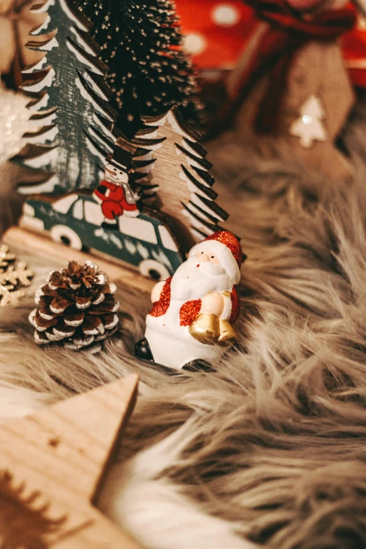 two small snowmen on display in front of a christmas tree