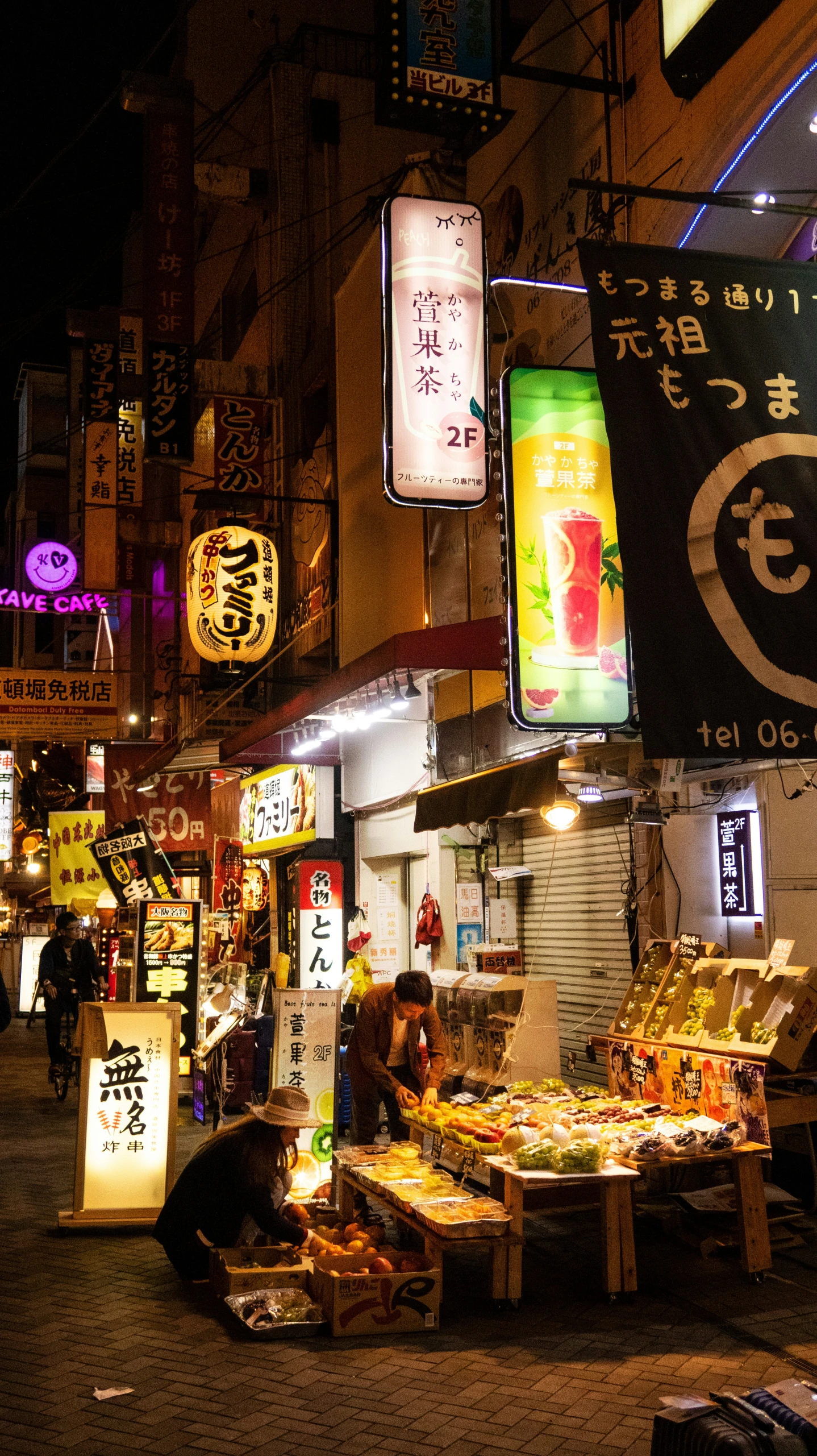 a small market on the street corner is lit up at night