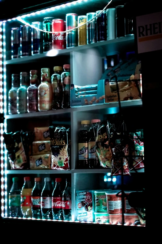 lighted shelves of different kinds of drinks in a store