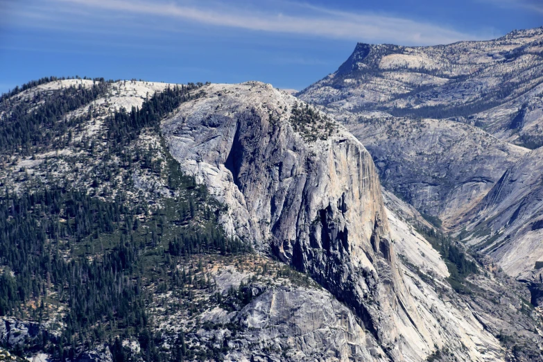 the mountains are covered with trees and rock