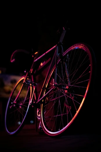 the bike is glowing in the dark on the road