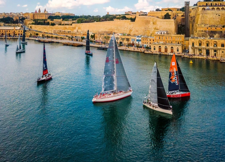 a group of sail boats on a body of water