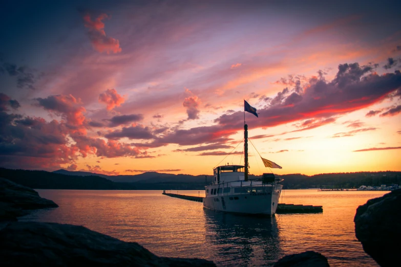 a large boat on a lake with clouds