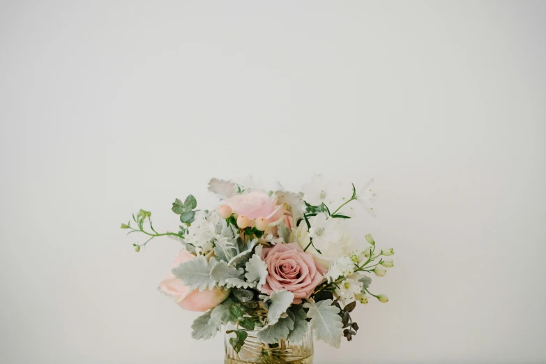 an assortment of flowers in a glass jar