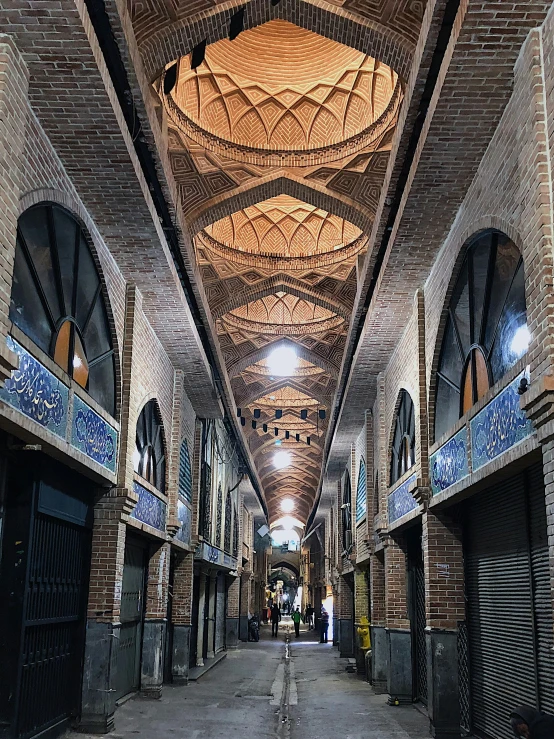 a narrow alley with many windows and stalls