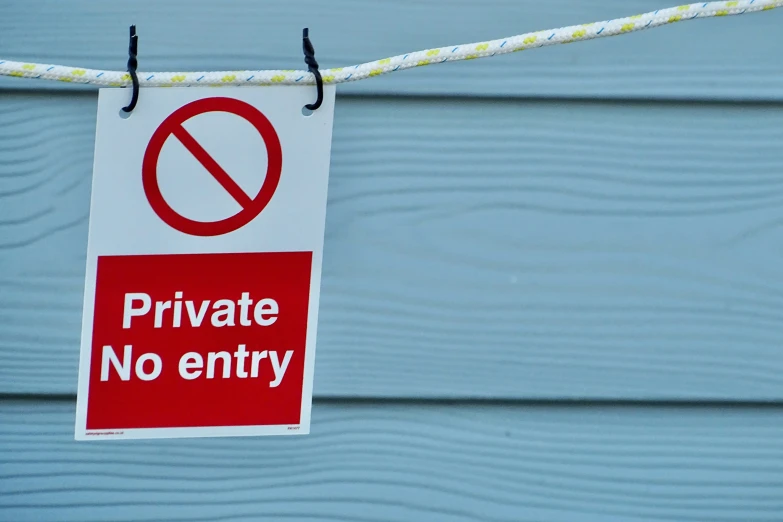 an anti - private sign hanging on the rope of a house