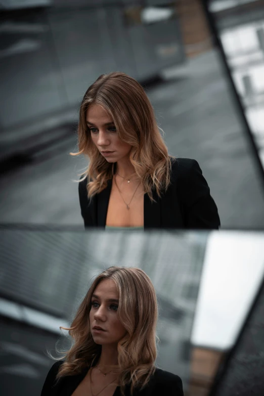 woman in a black suit looking into the distance