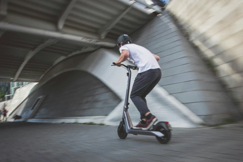 this is an image of a man riding an electric scooter