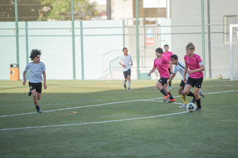 boys in uniform playing soccer on the field