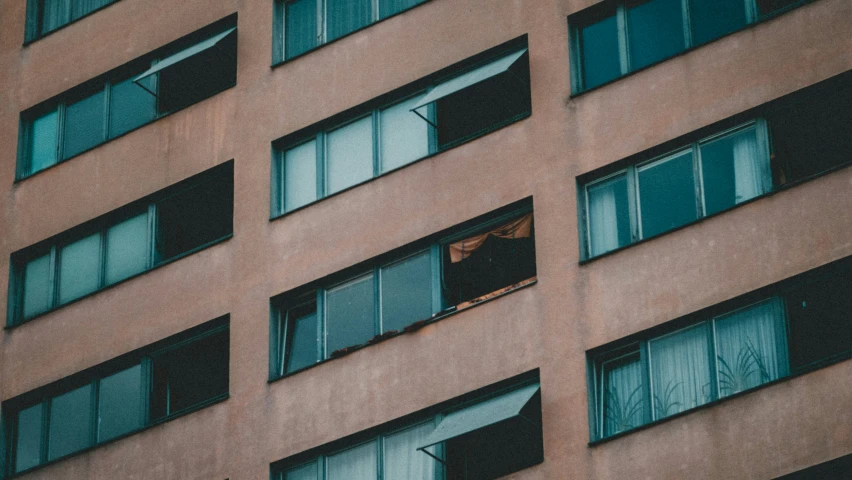 an apartment building with several windows and the roof is shattered