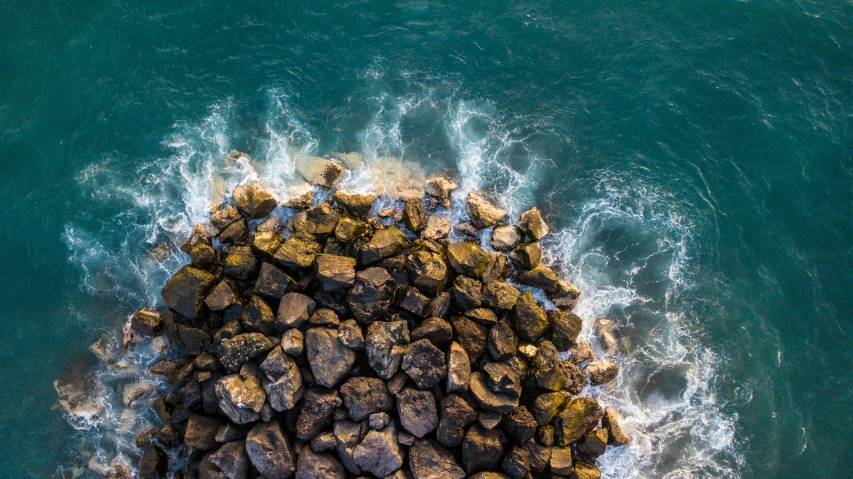 a bird's eye view of rocks and the ocean