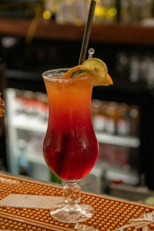 a glass filled with a drink and a slice of lime on top