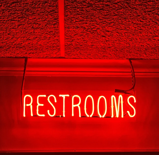 a red room with a neon sign on the wall
