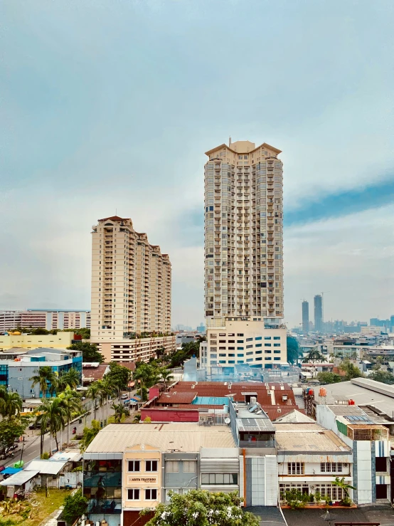 a city skyline with buildings and large buildings in the distance