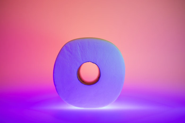 a very colorful, circular object on a purple background