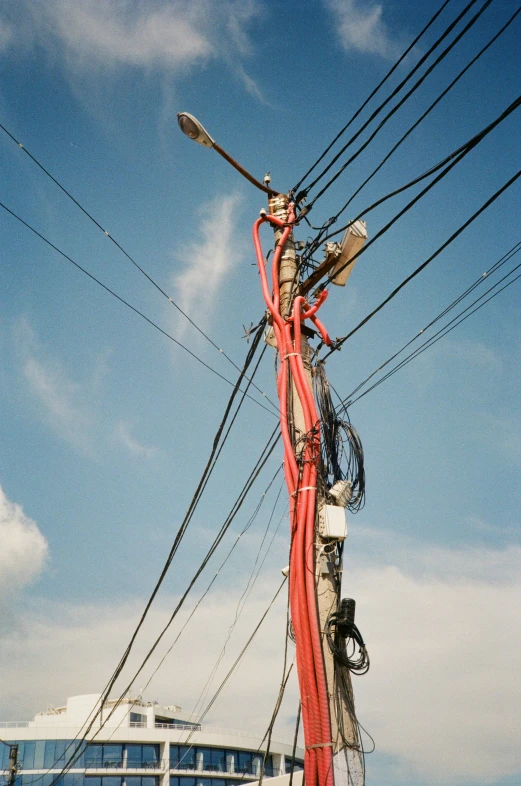 a street pole with some telephone wires next to it