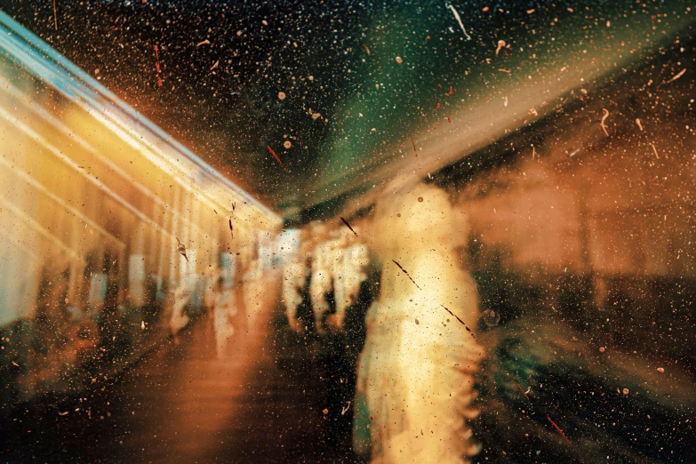 a blurred image of people and train tracks