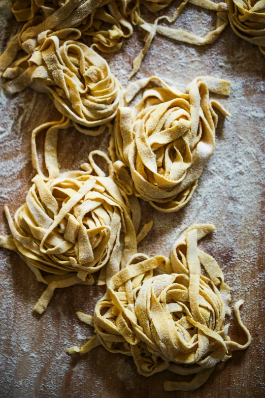 three peeled pieces of noodles sitting on top of a table